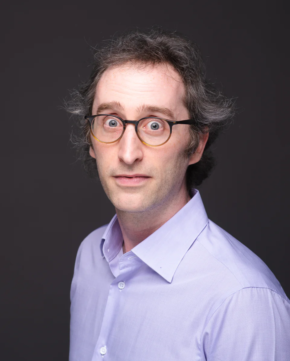 Jordan Humphreys wearing glasses with a surprised expression.